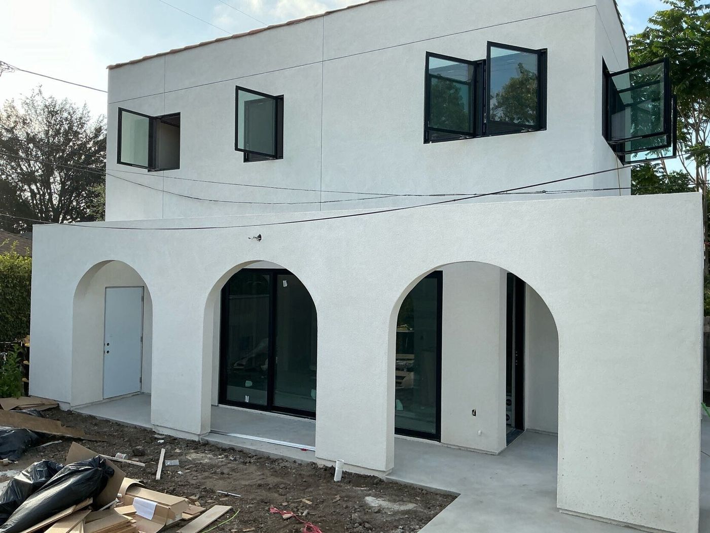 Two-story residence, arched loggia and steel windows